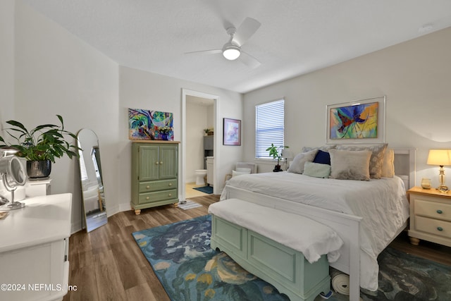 bedroom featuring ceiling fan, dark hardwood / wood-style floors, and ensuite bathroom