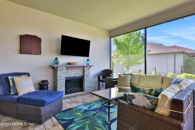 living room with a textured ceiling and a fireplace