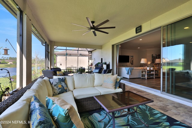 sunroom featuring ceiling fan