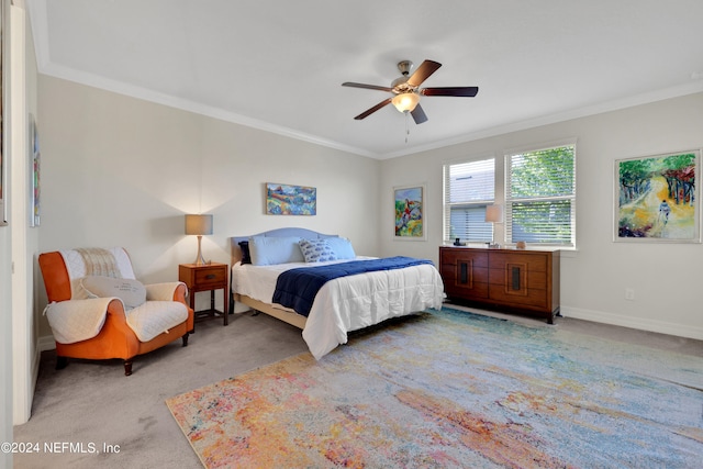 bedroom with carpet floors, ceiling fan, and crown molding