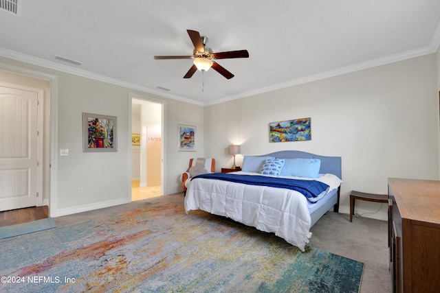 carpeted bedroom with ornamental molding and ceiling fan