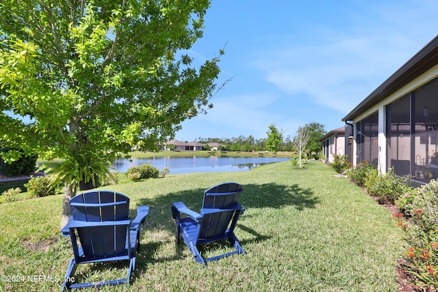 view of yard with a water view and a sunroom