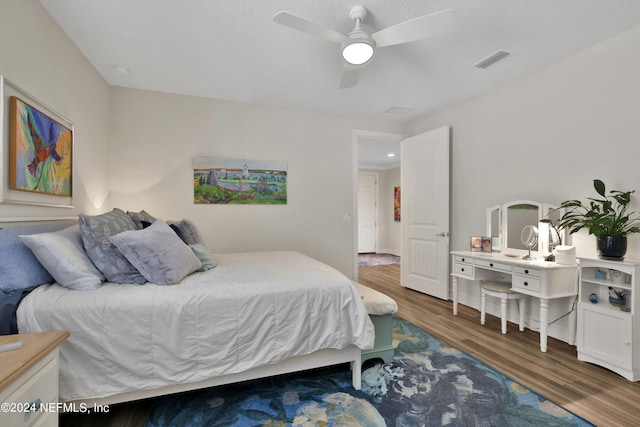 bedroom featuring ceiling fan and dark wood-type flooring