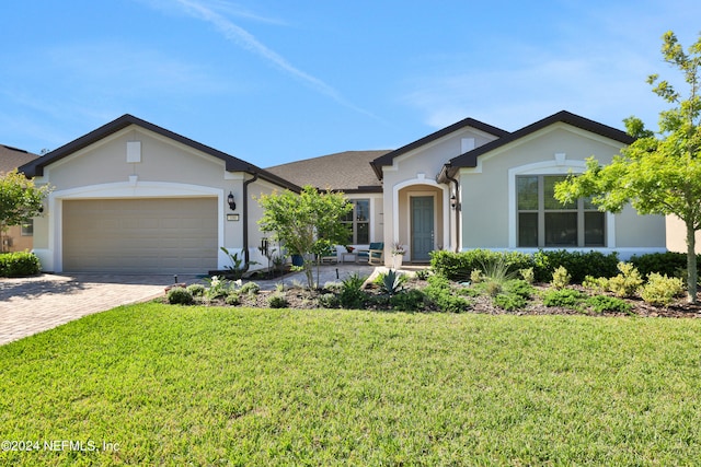 single story home featuring a front yard and a garage