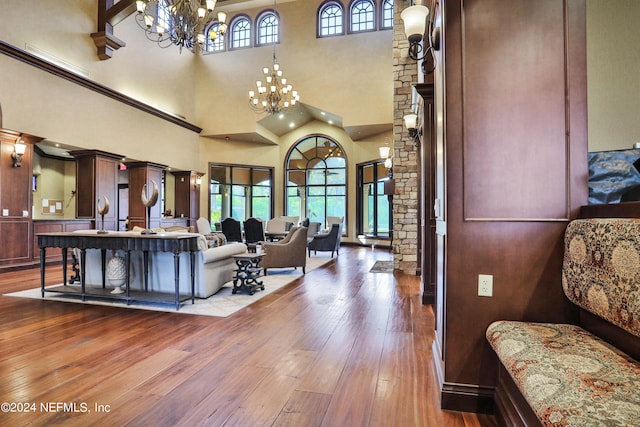 living room featuring a notable chandelier, a high ceiling, and dark hardwood / wood-style flooring