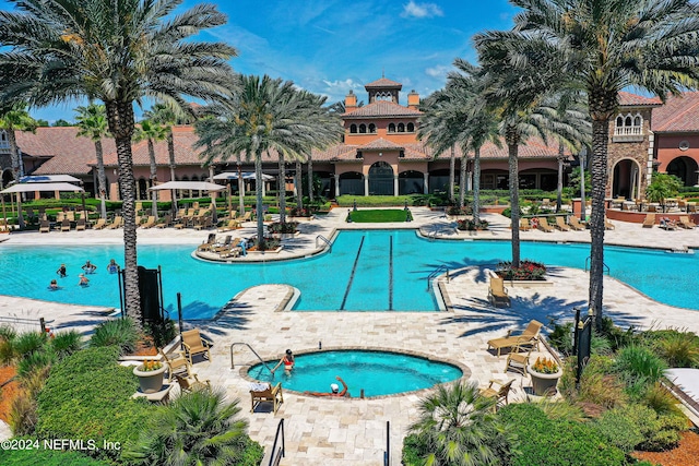 view of pool with a community hot tub and a patio area