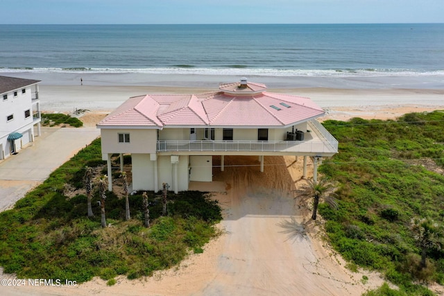 exterior space featuring a beach view and a water view