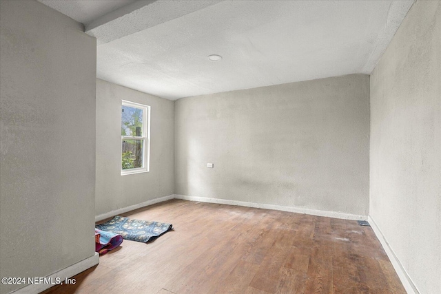 unfurnished room featuring hardwood / wood-style flooring