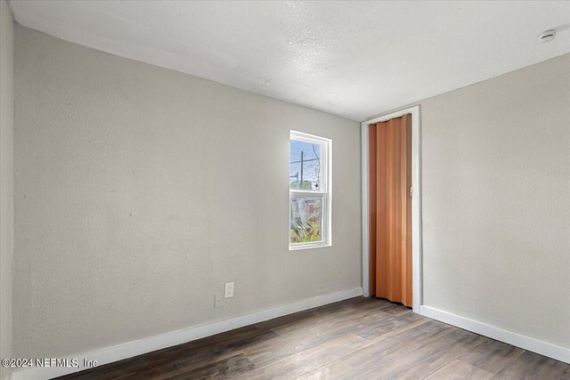 empty room with wood-type flooring