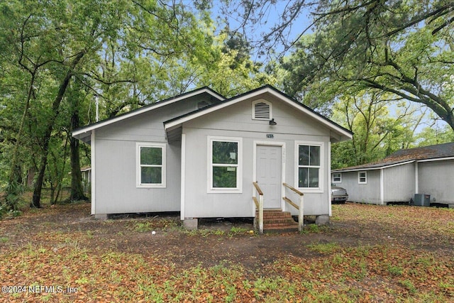 rear view of house featuring central AC unit