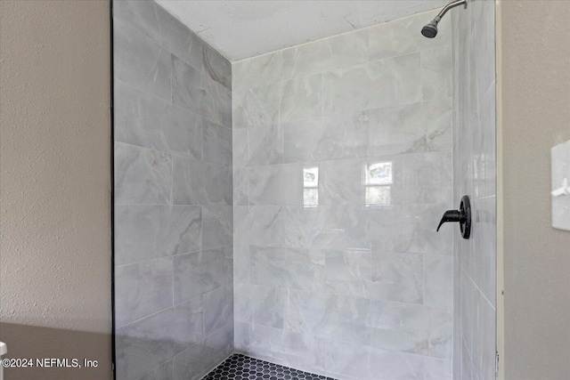 bathroom with tiled shower