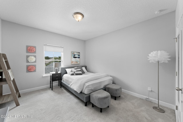 carpeted bedroom with a textured ceiling