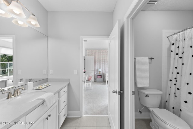 bathroom with tile patterned floors, a shower with curtain, vanity, a textured ceiling, and toilet