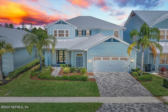 view of front of property featuring a yard and a garage