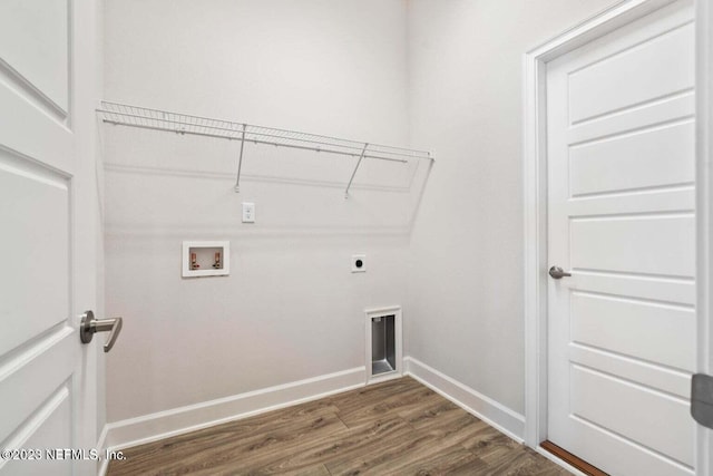 clothes washing area featuring hookup for an electric dryer, laundry area, washer hookup, baseboards, and dark wood finished floors