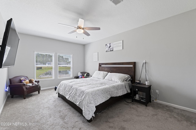 carpeted bedroom with a textured ceiling and ceiling fan