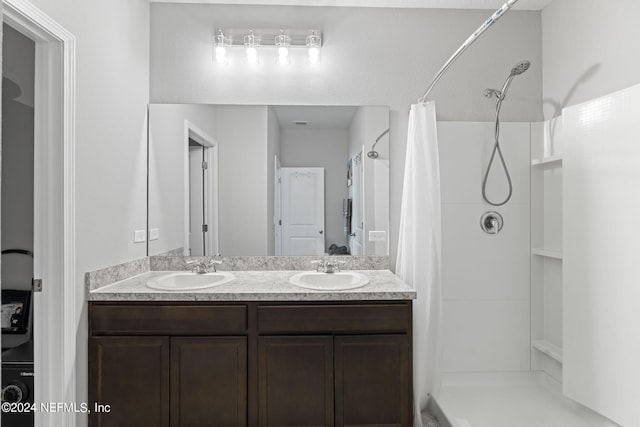 bathroom with a shower with curtain and dual vanity