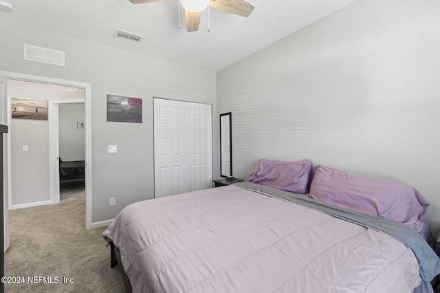 carpeted bedroom with a closet, ceiling fan, and lofted ceiling