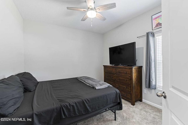 bedroom featuring ceiling fan and light carpet