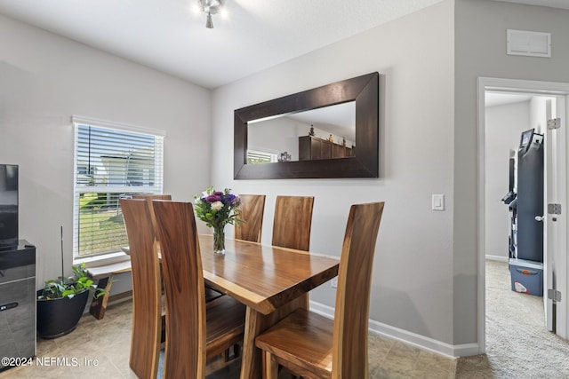 dining space featuring light tile floors