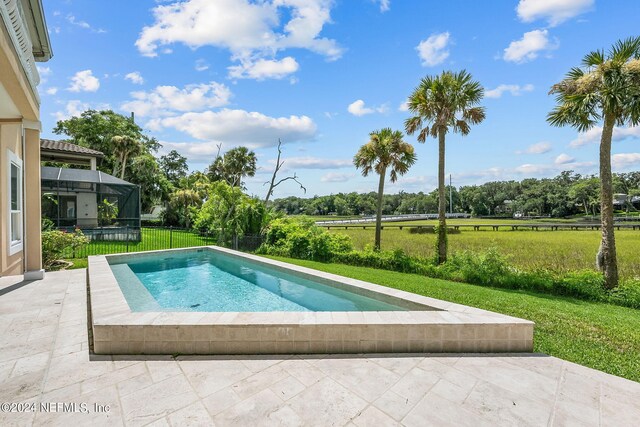 view of pool with a lanai, a yard, and a patio