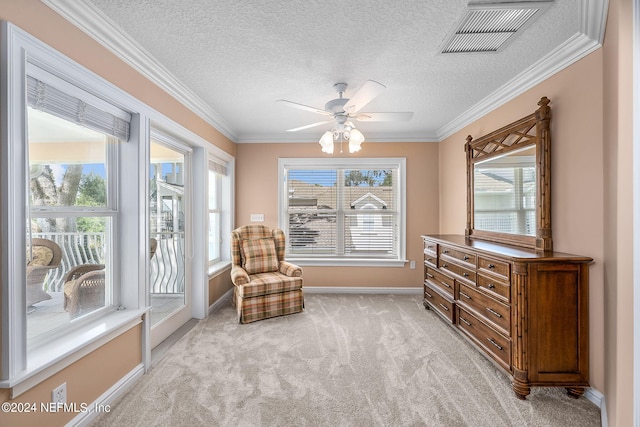 living area with light carpet, plenty of natural light, and ornamental molding