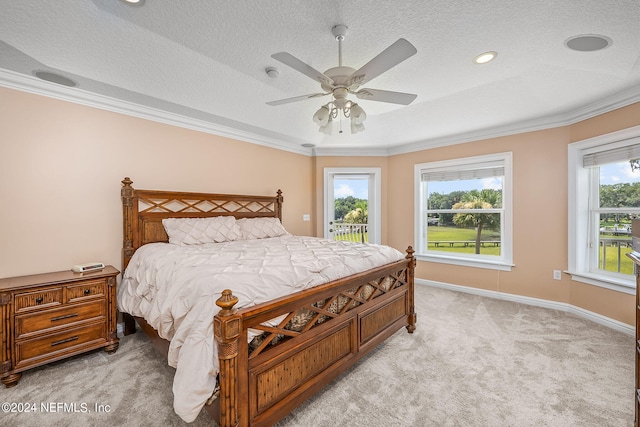 carpeted bedroom with multiple windows, ceiling fan, a textured ceiling, and ornamental molding