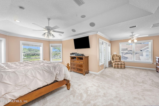 bedroom featuring light carpet, a textured ceiling, ceiling fan, and ornamental molding