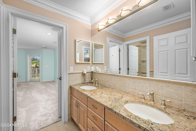 bathroom with tile patterned floors, crown molding, a textured ceiling, decorative backsplash, and vanity