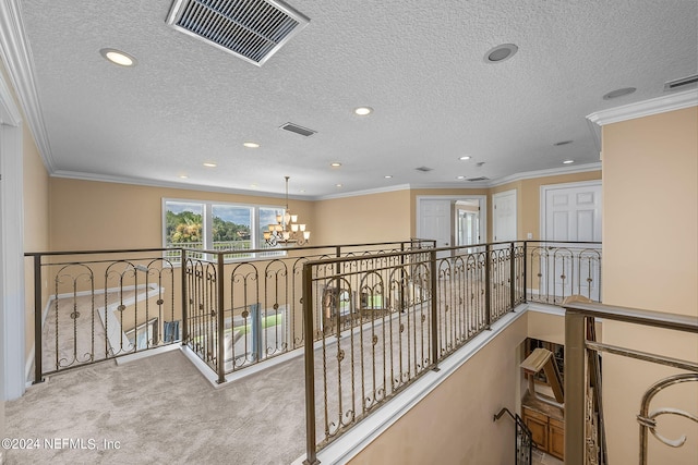 corridor featuring a chandelier, light colored carpet, and crown molding