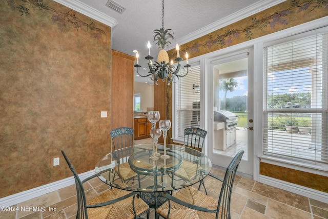 dining area featuring a healthy amount of sunlight, a chandelier, a textured ceiling, and ornamental molding