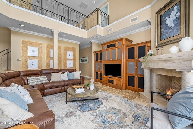 living room featuring a towering ceiling and crown molding