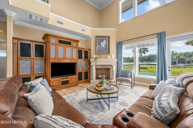 living room featuring crown molding, a high ceiling, and a high end fireplace