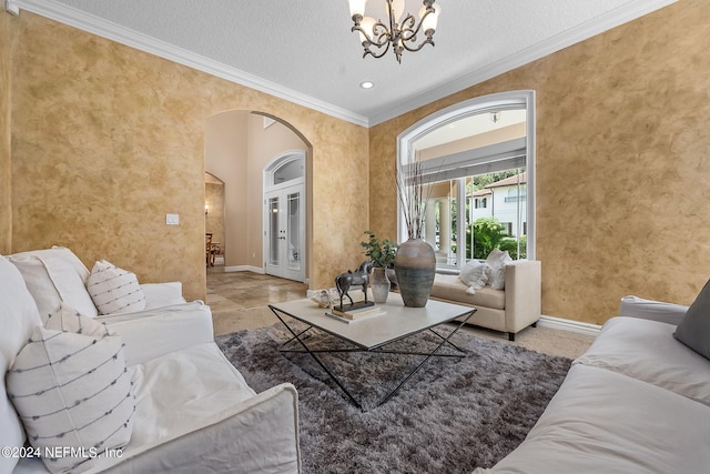 living room featuring french doors, a chandelier, a textured ceiling, and ornamental molding