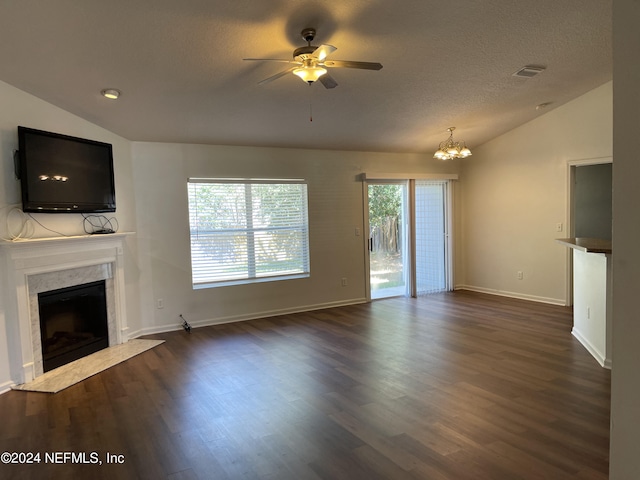 unfurnished living room featuring visible vents, dark wood-style flooring, vaulted ceiling, a textured ceiling, and a high end fireplace