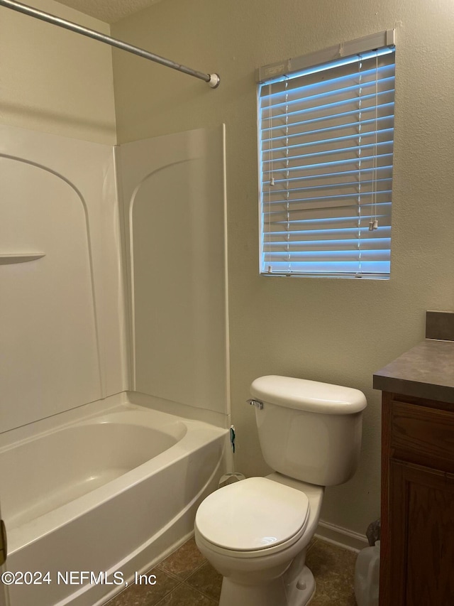 full bathroom with toilet, vanity, shower / tub combination, tile patterned flooring, and baseboards