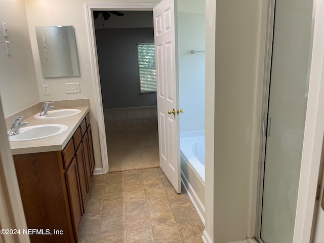 bathroom featuring double vanity, an enclosed shower, a sink, and a bath