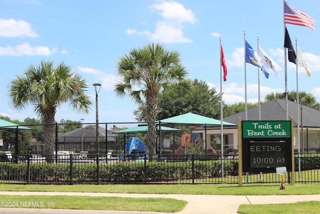 view of community featuring fence