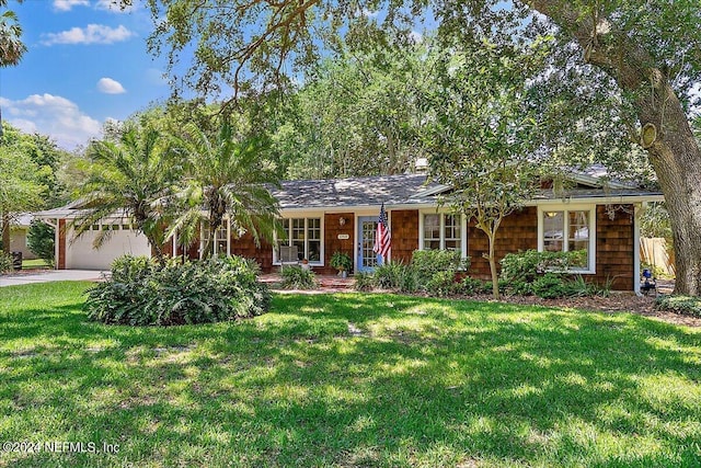 single story home featuring a garage, driveway, and a front lawn