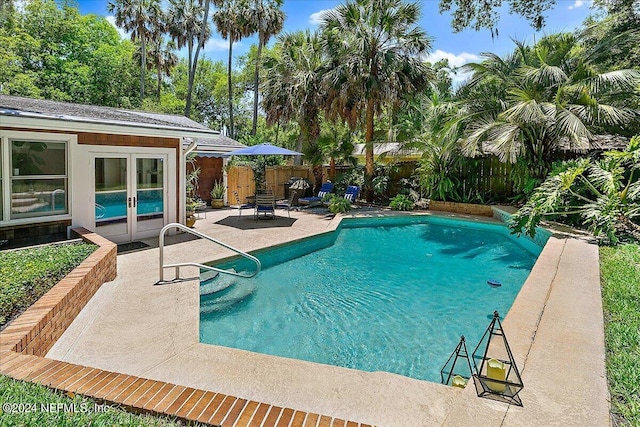 view of swimming pool featuring an outdoor structure and a patio area