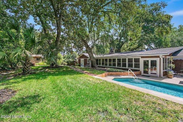 back of house with a yard, a patio area, and french doors