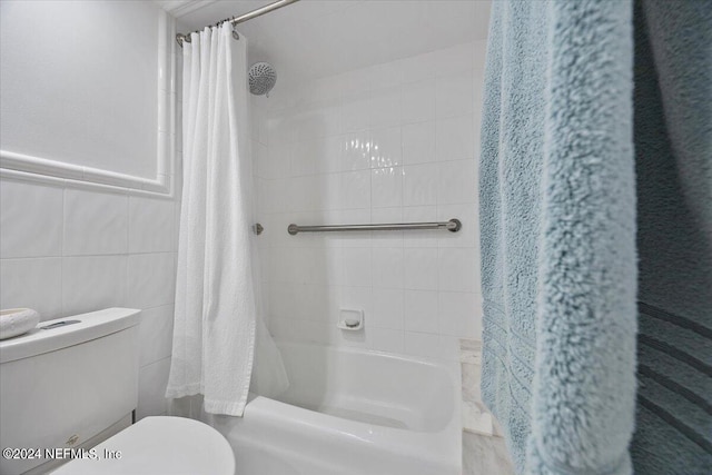 bathroom with shower / bath combo, tile walls, and toilet