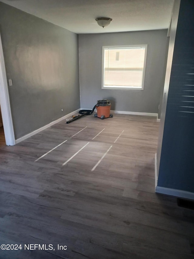 spare room featuring dark hardwood / wood-style flooring