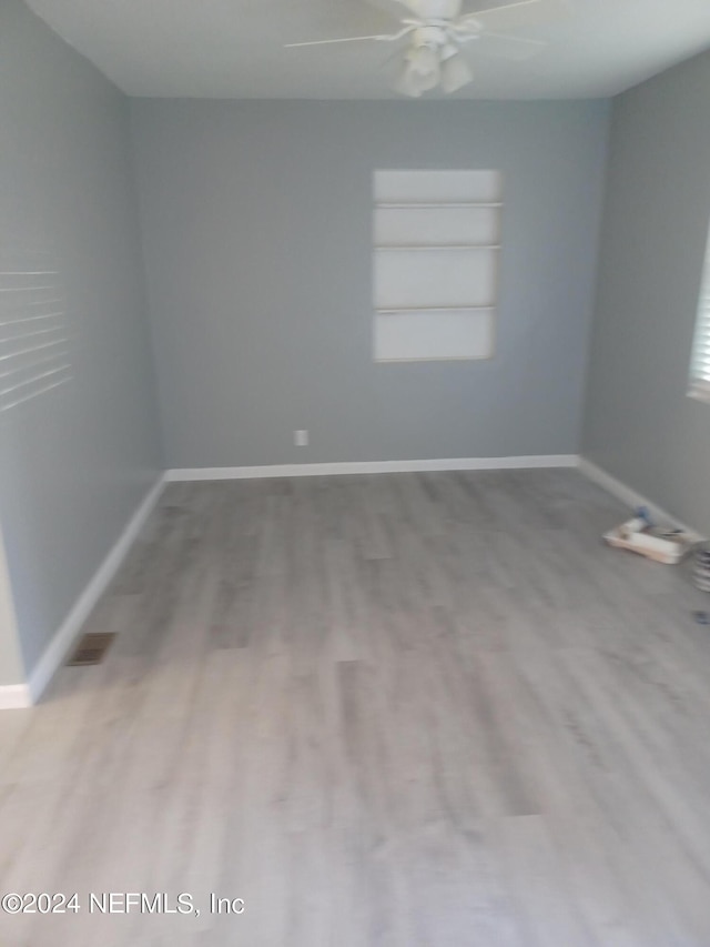 spare room with ceiling fan and hardwood / wood-style flooring