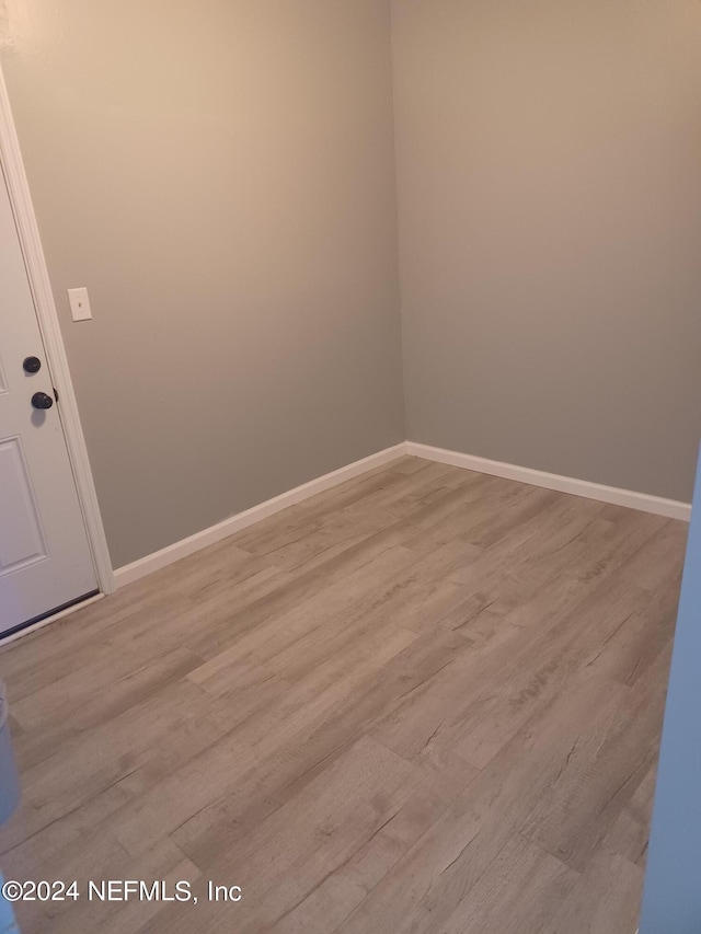 unfurnished room featuring hardwood / wood-style flooring