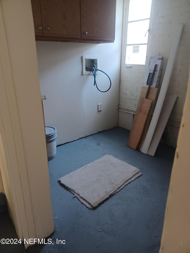 clothes washing area featuring cabinets