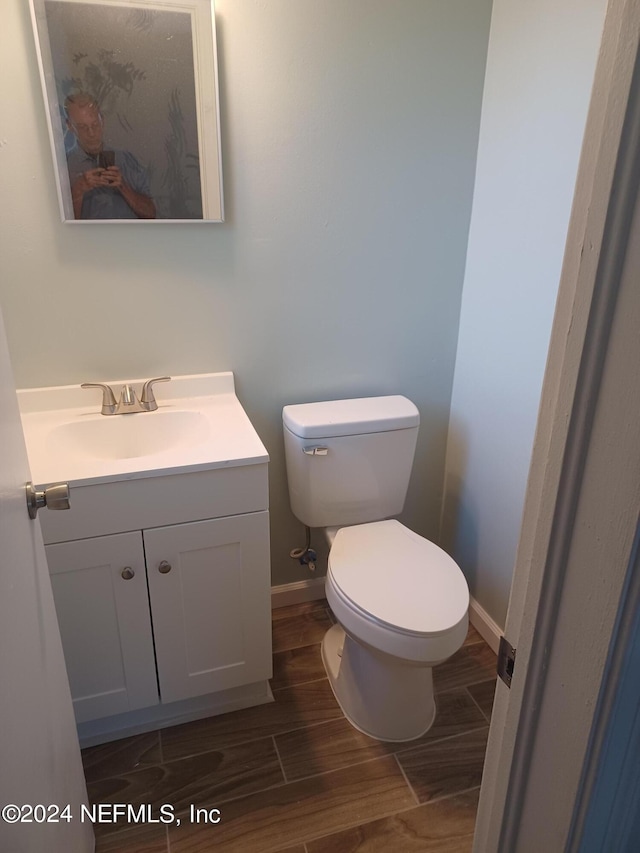 bathroom featuring vanity and toilet