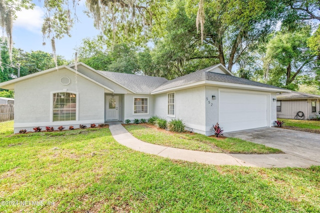 ranch-style home with a garage and a front lawn