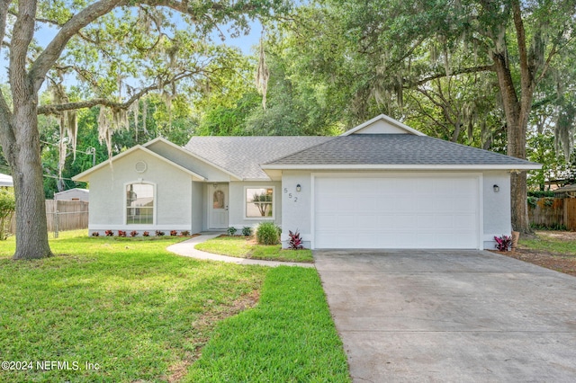 ranch-style house featuring a front yard and a garage