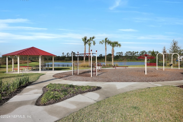 view of jungle gym featuring a water view, a lawn, and a gazebo